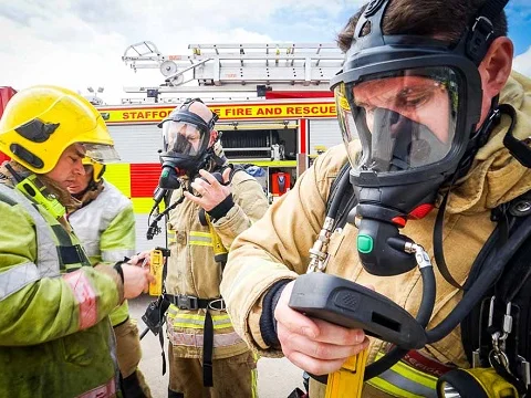 Firefighters wearing full-face self-contained breathing apparatus masks